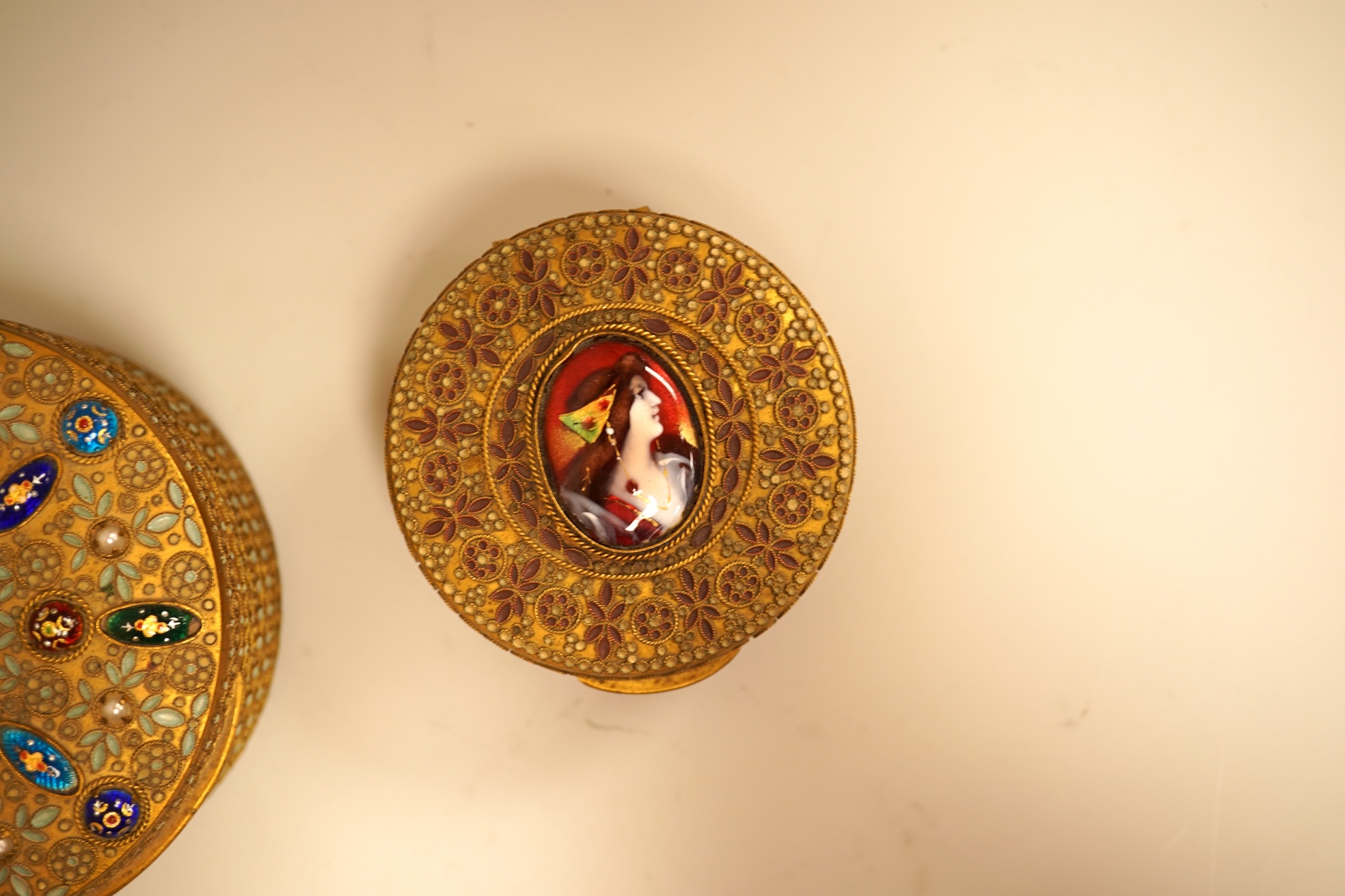 Two Limoges enamel mounted gilt filigree work circular boxes, largest 8cm diameter